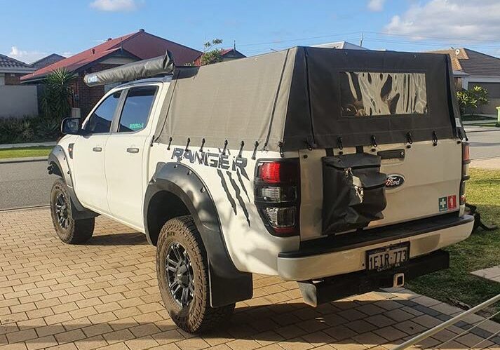 Canvas ute canopy with camping bag attached to tray.