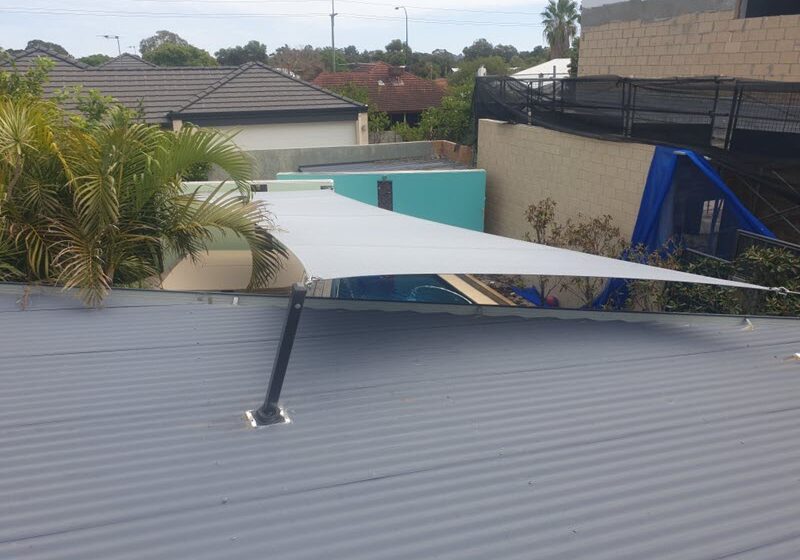 Custom shade sail mounted to home roof.